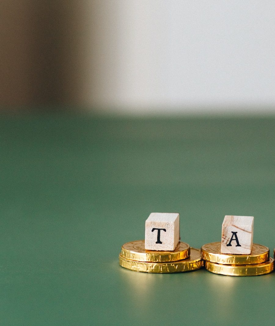 Tax Word on Top of Gold Coins